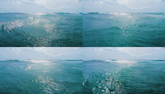 海滩上的流浪汉，近距离拍摄的白色泡沫的海浪在印度尼西亚的巴厘岛高清在线视频素材下载