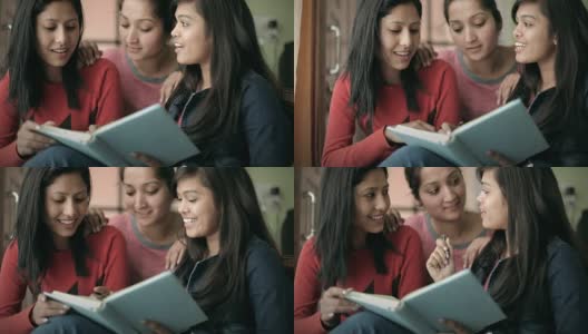 青少年晚期的快乐女孩学生一起学习一本书。高清在线视频素材下载