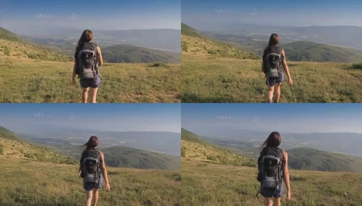 年轻的徒步女行走在山顶上，摄像机稳定拍摄高清在线视频素材下载