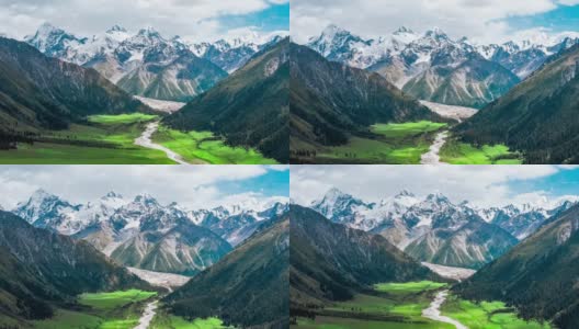 空中拍摄的新疆绿色草原和雪山景观高清在线视频素材下载