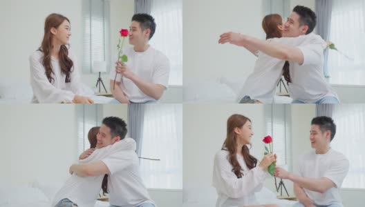 亚洲青年惊喜送玫瑰给美丽的女友。迷人浪漫的新婚男女坐在床上，一起享受庆祝周年纪念日和情人节高清在线视频素材下载