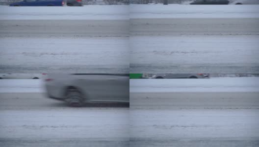 冬天的马路，过往的汽车，车轮。积雪覆盖的道路上的交通。高清在线视频素材下载