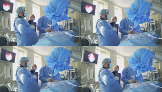 外科医生在手术室工作。一群外科医生带着手术设备在手术室里。高清在线视频素材下载