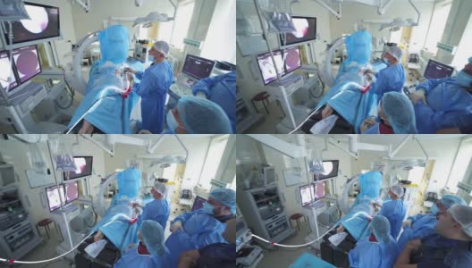 手术室正在进行手术。医疗团队在明亮的现代化手术室进行外科手术高清在线视频素材下载