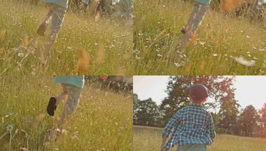 SLO MO TS男孩在阳光照耀的草地上奔跑高清在线视频素材下载