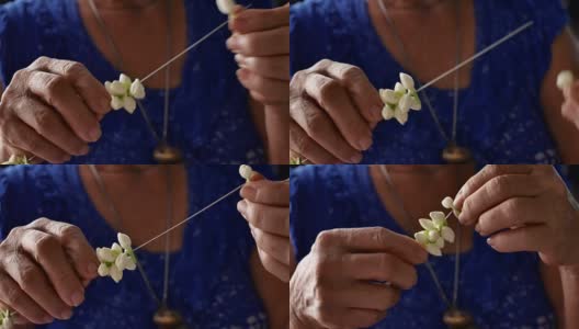 亚洲老妇人制作茉莉花花环高清在线视频素材下载