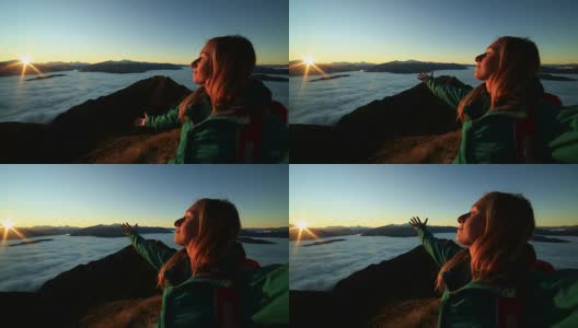 这是一个在山顶上张开双臂的女人的肖像高清在线视频素材下载