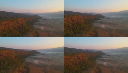 鸟瞰村庄和农村贫瘠的土地在日出，背景山。高清在线视频素材下载