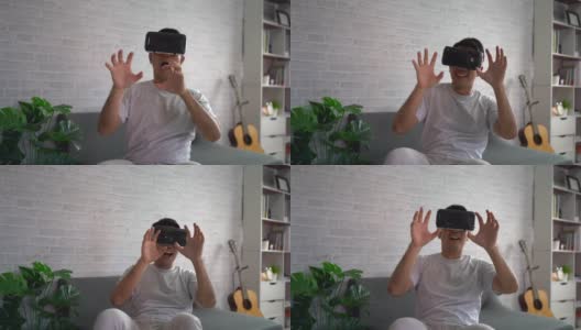 亚洲男人在家玩虚拟现实游戏娱乐，亚洲男人在假期在家快乐。快乐女人玩超时空VR技术概念。高清在线视频素材下载