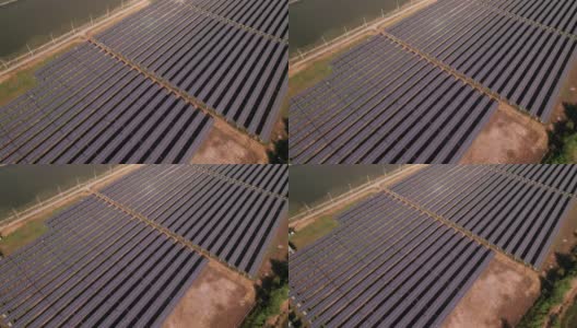 鸟瞰图，整个大型太阳能电池板农场在农村附近的农业农场，生产清洁的太阳能电力高清在线视频素材下载
