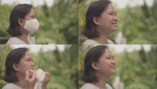 亚洲女性摘下面具，在大自然中微笑高清在线视频素材下载