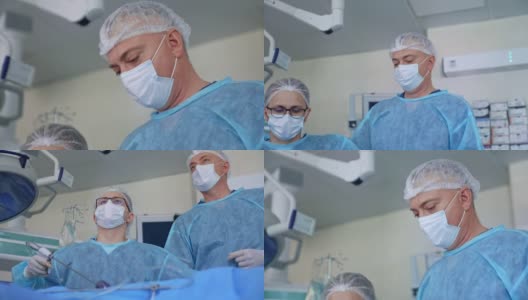 由专家进行的外科手术。穿着医疗制服的医生在现代手术室进行手术的团队合作。高清在线视频素材下载