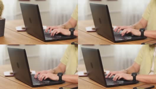 男人在笔记本电脑上打字，在家里或办公室的电脑上工作高清在线视频素材下载
