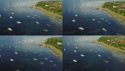 4K:无人机拍摄的萨努尔Mertasari海滩鸟瞰图。一些传统渔船(jukung)停泊在浅水区。高清在线视频素材下载