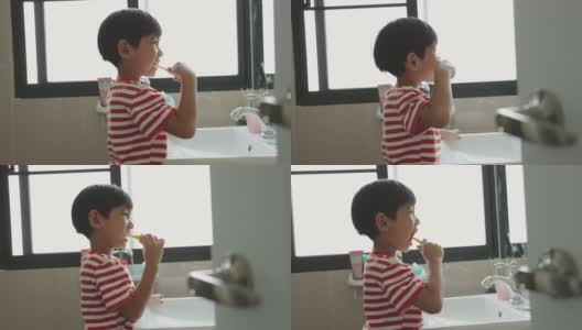 亚洲男孩刷牙是为了防止蛀牙。孩子们吃完饭后要注意口腔卫生。高清在线视频素材下载