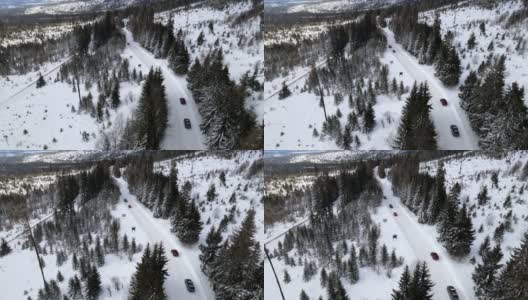 汽车在雪山道路上移动的鸟瞰图高清在线视频素材下载