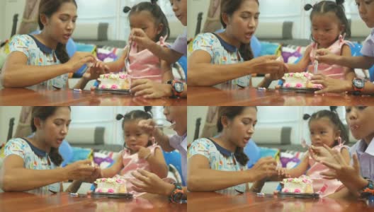 小女孩和家人一起吃生日蛋糕高清在线视频素材下载