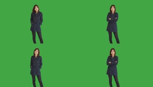 年轻的亚洲妇女站在绿色屏风的背景下孤立。中国女性人物肖像。高清在线视频素材下载