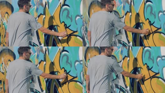一位男艺术家重新绘制了一面古老的涂鸦墙。高清在线视频素材下载