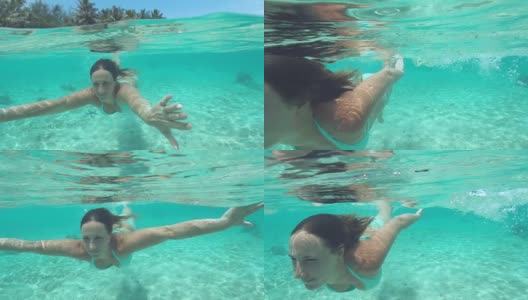 特写:微笑的女人在绿松石比基尼潜水附近的热带岛屿。高清在线视频素材下载