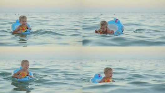 带着橡皮圈的男孩在海里游泳高清在线视频素材下载
