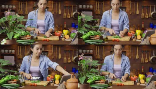 数字片剂配方:多利拍摄的西班牙年轻女子切菜准备食物高清在线视频素材下载
