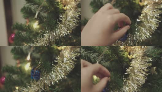 POV女士手把礼物盒装饰挂在圣诞树上高清在线视频素材下载