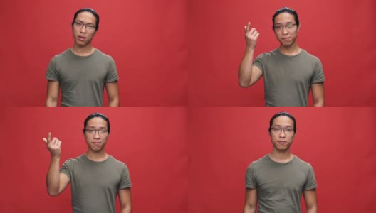 一头雾水的亚洲男人穿着t恤戴着眼镜，手指贴着太阳穴高清在线视频素材下载