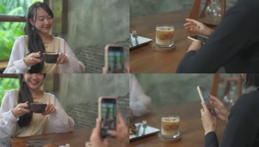 一群亚洲女性朋友在咖啡店见面，一起用智能手机自拍高清在线视频素材下载
