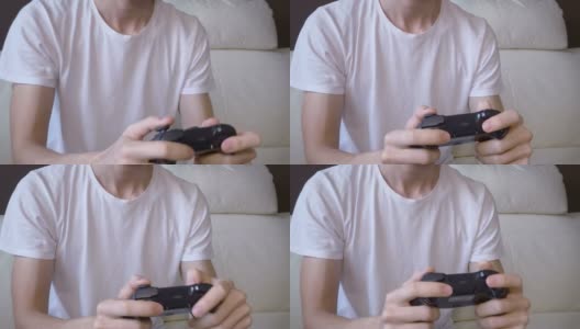四分之三的观点，年轻的不认识的成年男子玩电子游戏高清在线视频素材下载