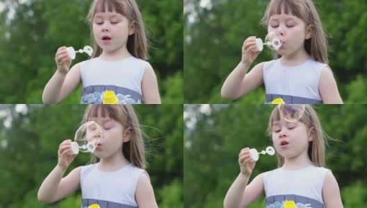 一个可爱的小女孩在春天的公园里吹蒲公英。快乐的孩子在户外玩得开心高清在线视频素材下载
