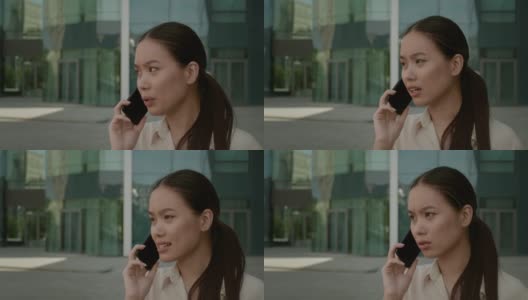 日本女商人站在市区打电话高清在线视频素材下载