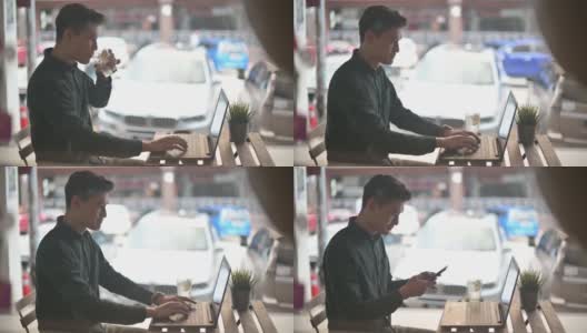 微笑的专业年轻亚洲华人商人在露天咖啡馆用笔记本电脑工作高清在线视频素材下载