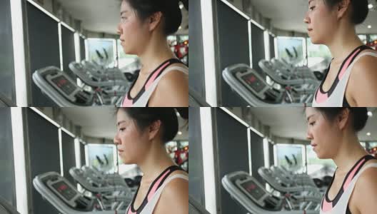 运动女性在跑步机上跑步高清在线视频素材下载