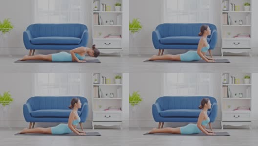 健康迷人的亚洲妇女在蓝色的穿着做瑜伽Cobra姿势在家里冥想舒适和放松，冷静的健康年轻女子深呼吸和冥想与瑜伽在家里，瑜伽概念高清在线视频素材下载