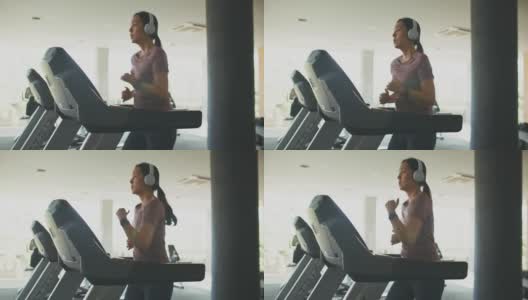 亚洲运动妇女在健身房的跑步机上锻炼高清在线视频素材下载