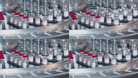 Sars-COV-2新型冠状病毒肺炎疫苗批量生产自动化流程该机为在制药输送带上移动的玻璃瓶盖上红帽。无尽的3d动画，重复的动作高清在线视频素材下载