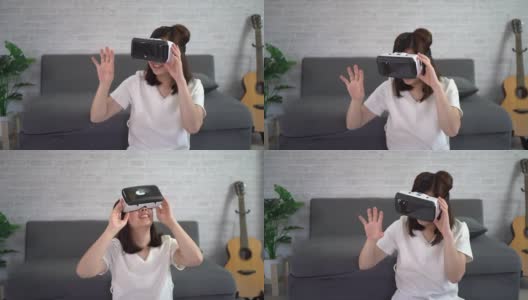 亚洲女性在家玩虚拟现实游戏，亚洲女性在假期在家快乐。快乐女人玩超时空VR技术概念。高清在线视频素材下载