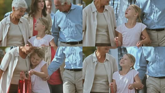 购物后，爷爷奶奶和孙女散步聊天高清在线视频素材下载