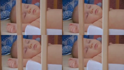 小婴儿睡在他的婴儿床里，靠近点高清在线视频素材下载
