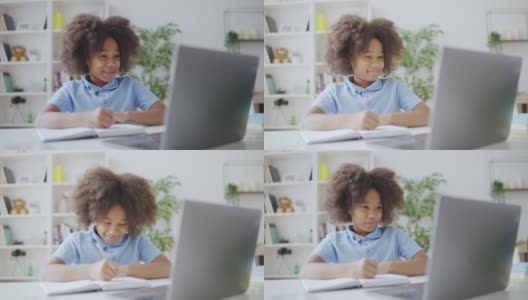 可爱的非洲裔美国女学生在家里用笔记本电脑上在线视频课高清在线视频素材下载
