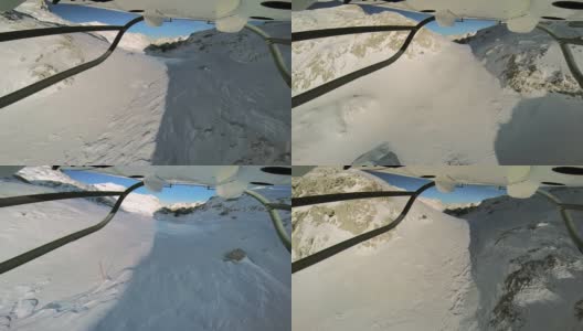 POV直升机飞过白雪覆盖的山顶高清在线视频素材下载