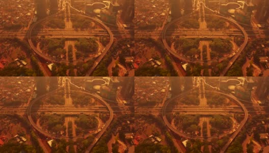 傍晚时分，印尼雅加达，新设的Semanggi高速公路交汇处的俯视图，有曲线桥和橙色的天空。拍摄分辨率为4k高清在线视频素材下载