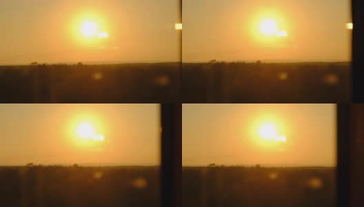 日落在地平线上的天空中，大的亮黄色的太阳在森林上方移动高清在线视频素材下载