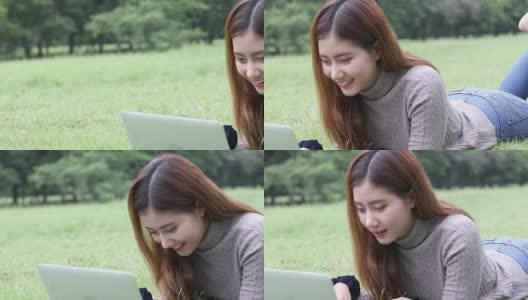 快乐的女学生带着笔记本电脑在公园里，摄影车拍摄高清在线视频素材下载