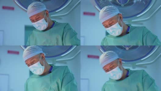 男性外科医生在诊所工作的肖像。戴医用口罩的医生正在做抽脂手术。专业医生做手术。高清在线视频素材下载