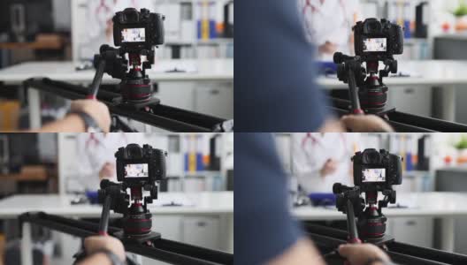 摄影师拍摄医生在相机上使用三脚架和滑块特写4k电影高清在线视频素材下载