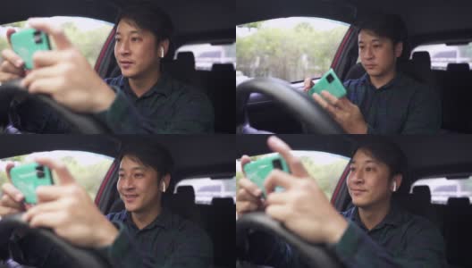 亚洲年轻人在停车时在车里用手机。高清在线视频素材下载