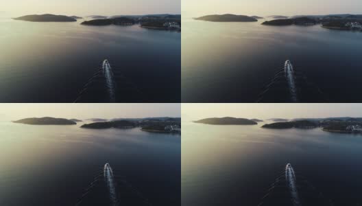 豪华快艇在欧洲地中海航行的航拍影像。在法国，摩纳哥，意大利或克罗地亚的游艇航行经验。平静海面上的阳光反射。高清在线视频素材下载