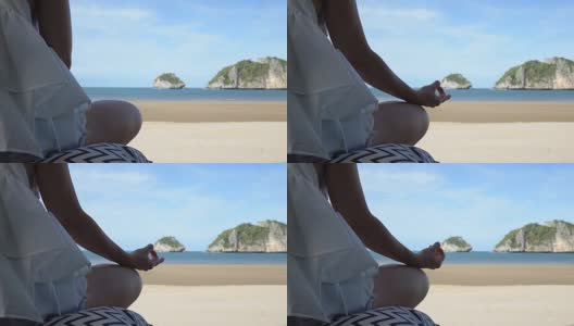 女人在美丽的海滩上沉思，感受阳光下的海景高清在线视频素材下载